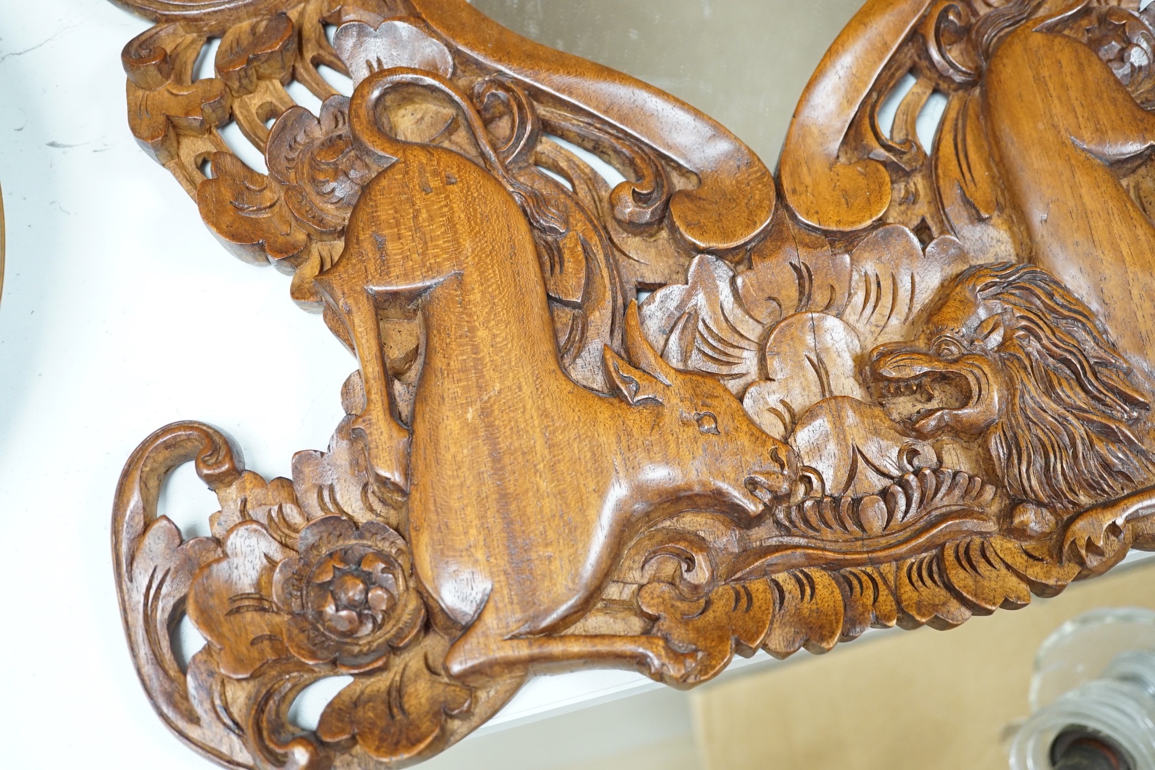 A Balinese carved wood wall mirror, 62cm long